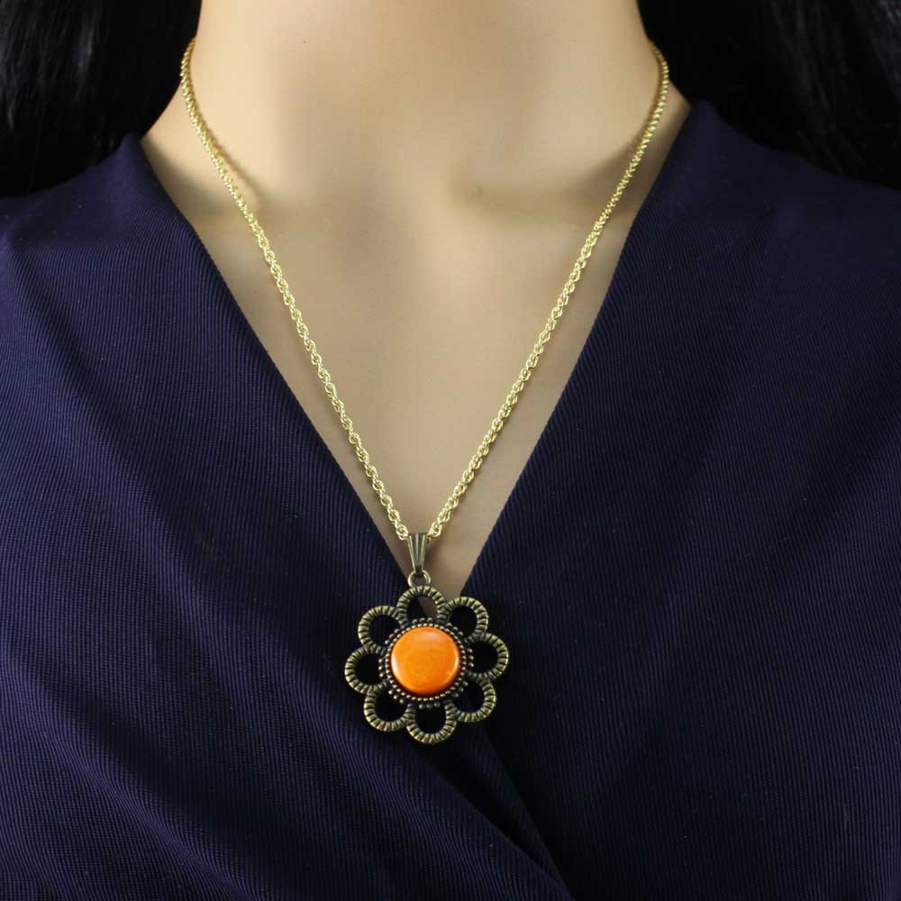 Necklace with an orange pendant on a model wearing a navy blue top - Lilylin Designs