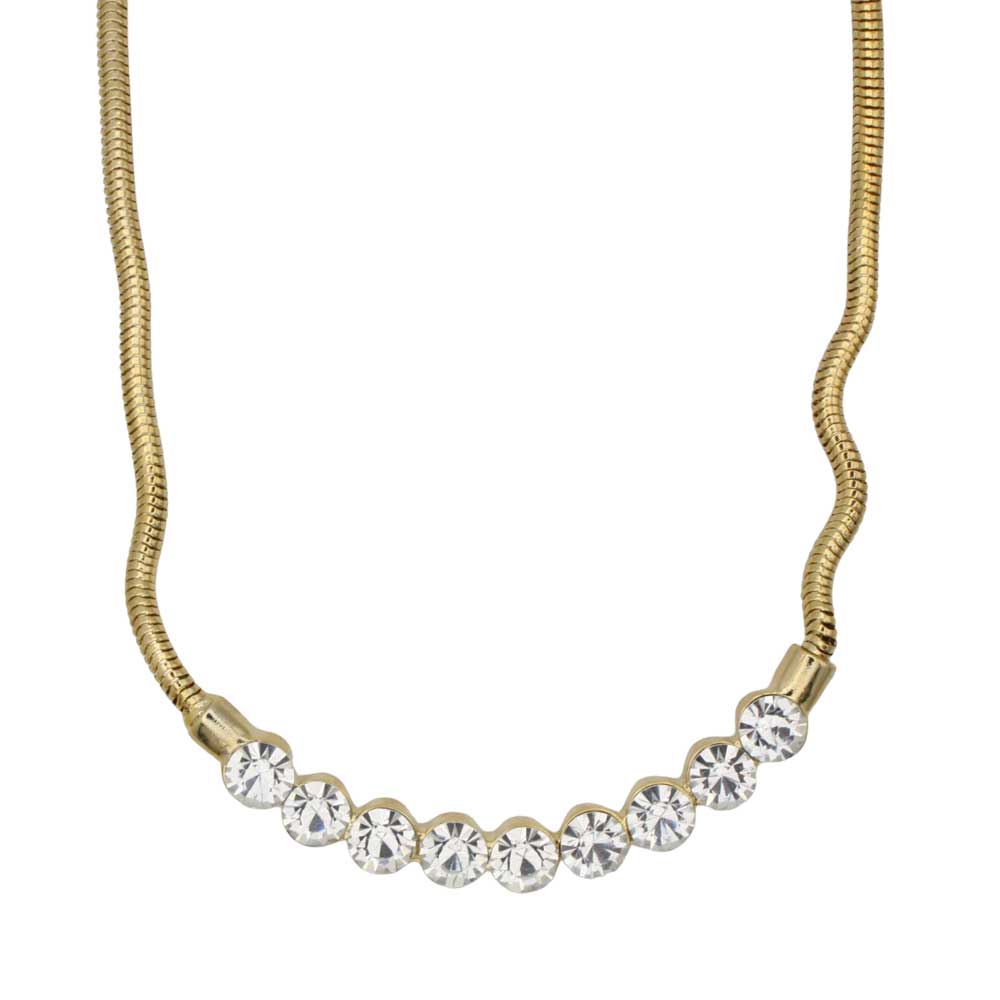 A gold snake chain necklace featuring a curved row of clear round-cut rhinestones set in gold bezels, shown against a plain white background. Lilylin Designs