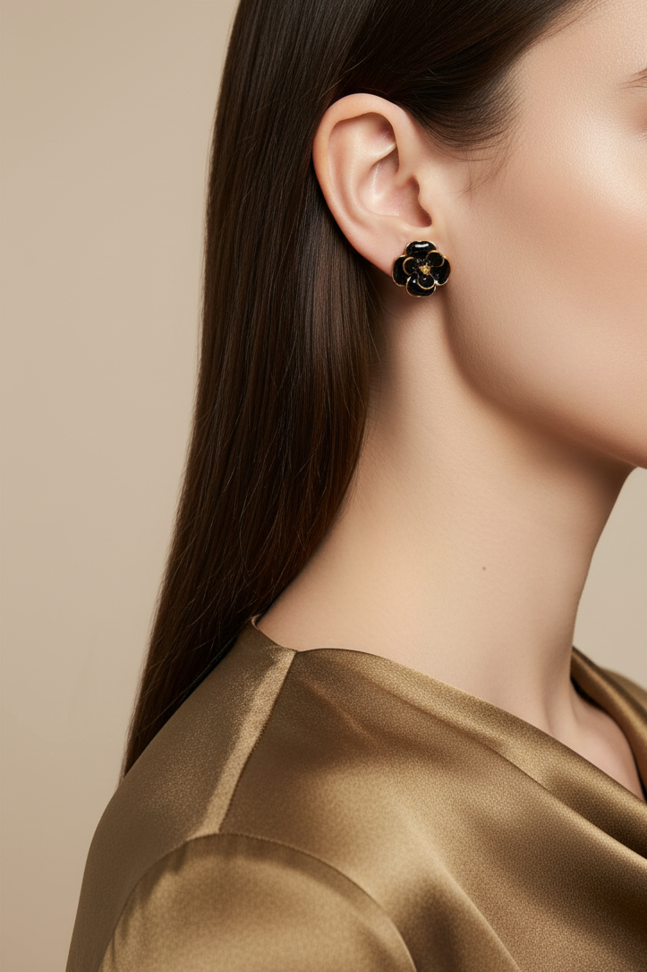 Model wearing black enamel flower  earring outlined in gold - Lilylin Designs