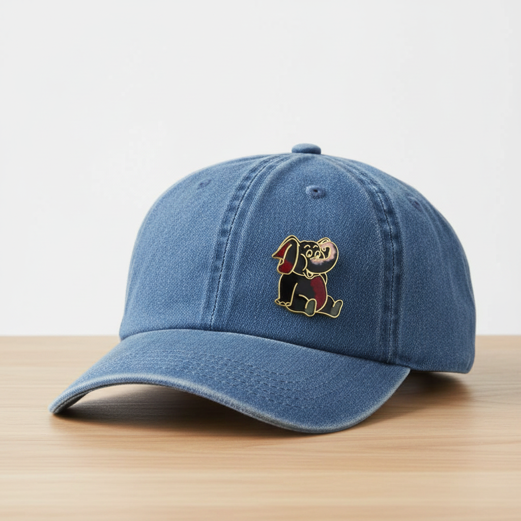 Black cloisonne elephant on denim baseball hat on countertop - Lilylin Designs