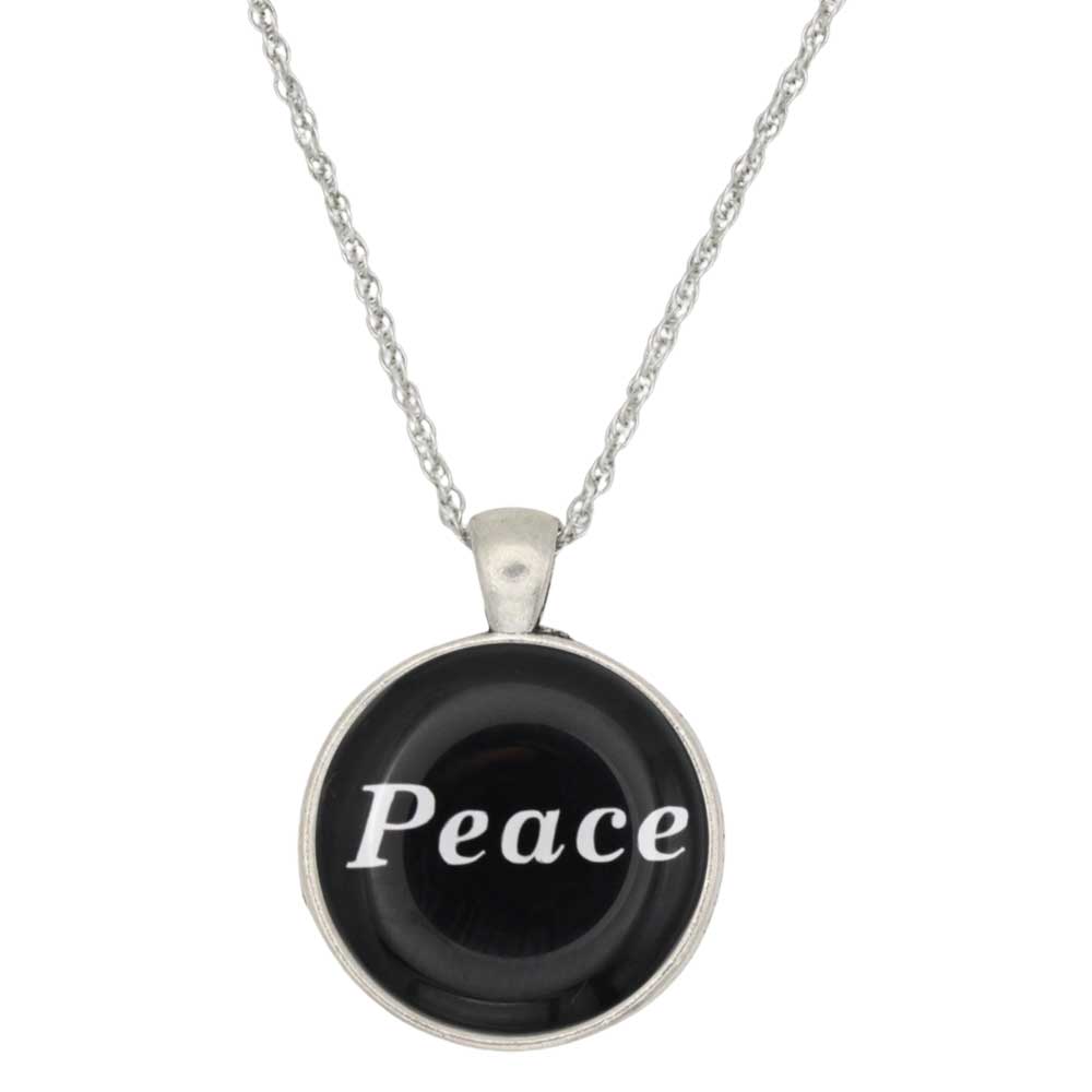 A silver chain necklace with a round pendant featuring a black background and the word 'Peace' in white script, shown on a plain white background - Lilylin Designs