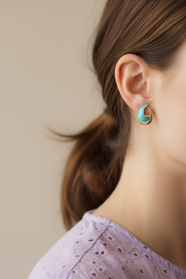 Model wearing blue and gold open teardrop earring - Lilylin Designs