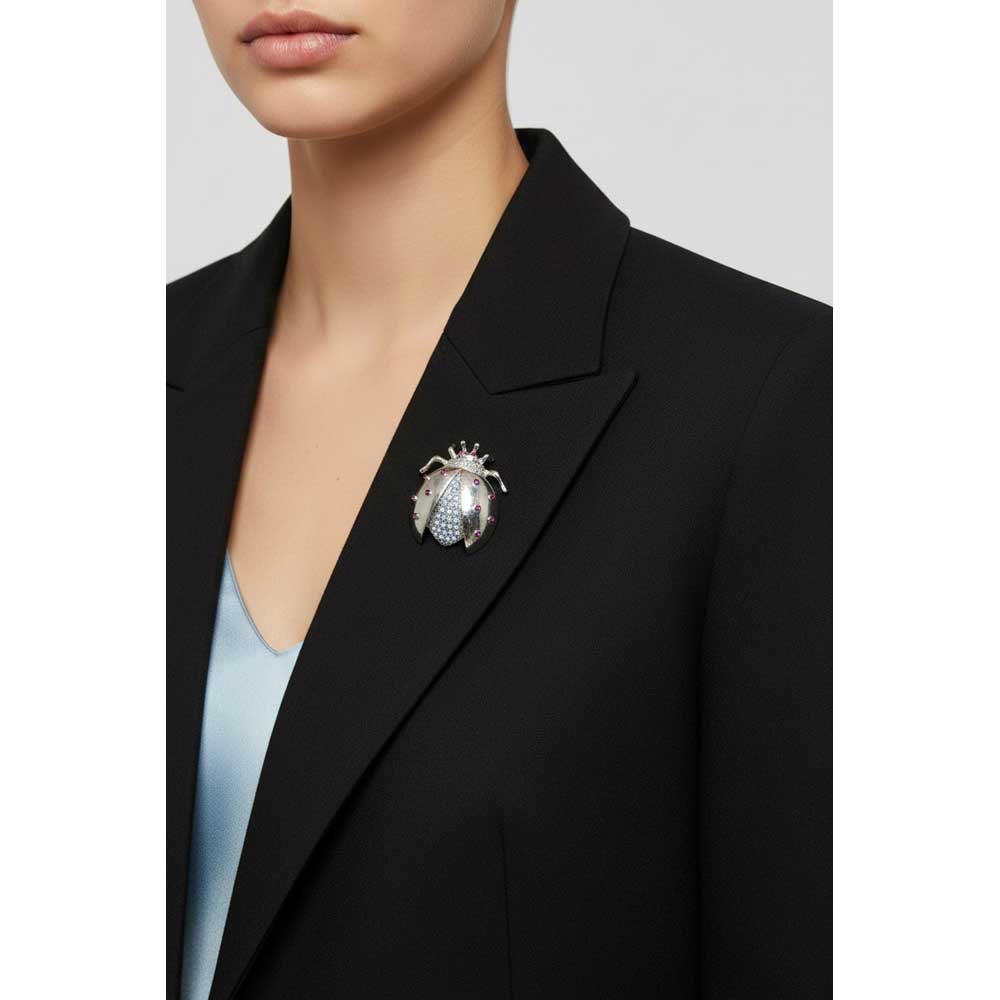 Model wearing blue and purple crystal ladybug brooch pin on a black jacket with a light blue top - Lilylin Designs