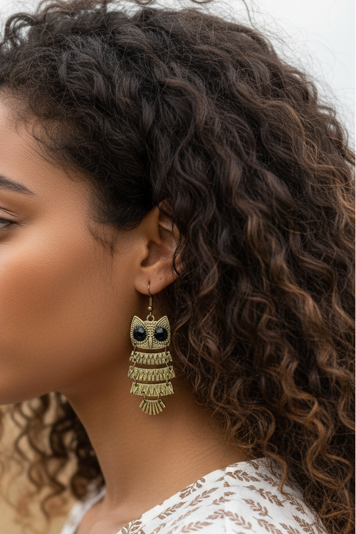 Model wearing antiqued gold-tone owl dangle earring - Lilylin Designs