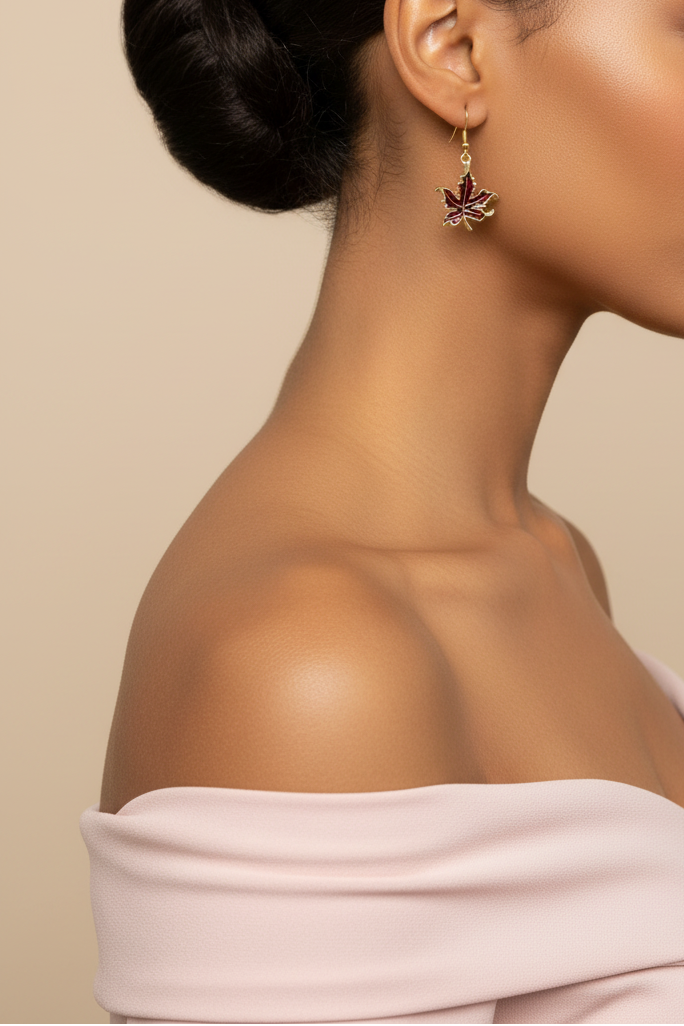 Model wearing a burgundy enamel maple leaf earring - Lilylin Designs