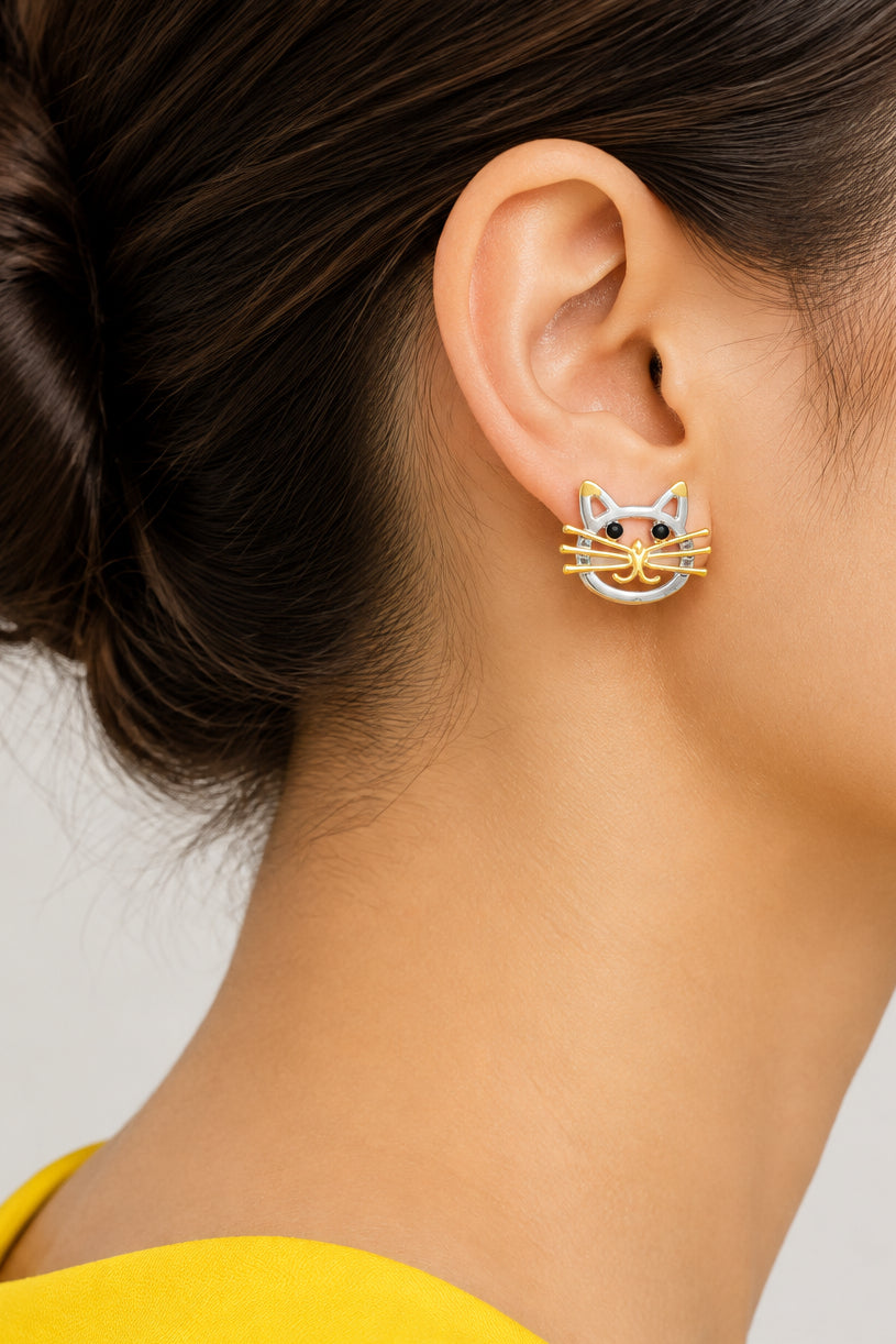 Model wearing silver and gold cat head with black eyes pierced earring - Lilylin Designs