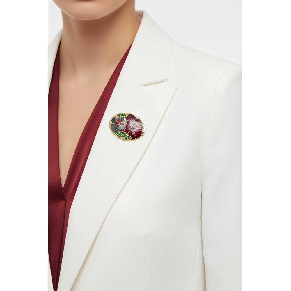 Model wearing red and gray hibiscus cloisonne brooch on a white jacket - Lilylin Designs