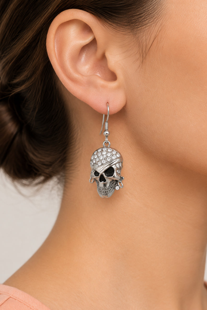 Model wearing crystal bandaged pirate skull pierced earring - Lilylin Designs