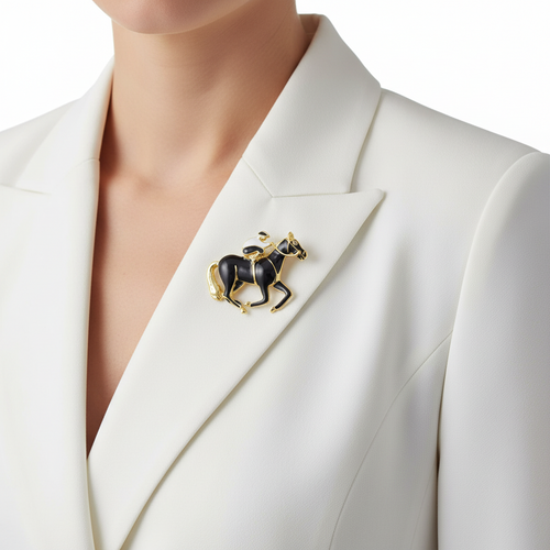 A close-up of a model wearing a black and gold horse brooch on their white blazer - Lilylin Designs