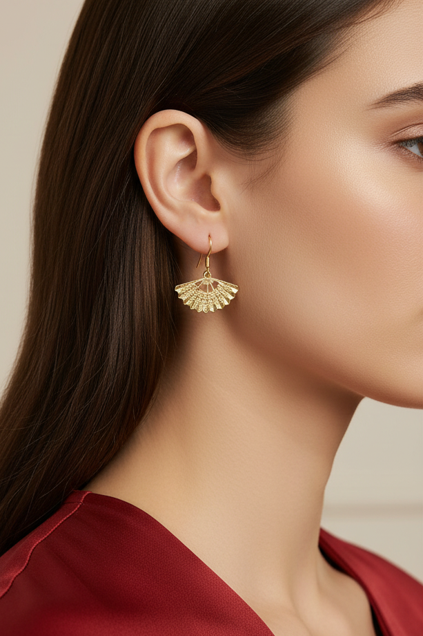 Model wearing embossed gold-tone fan dangle earring - Lilylin Designs