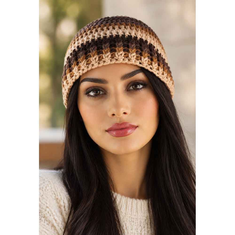 Front view of model wearing brown, tan, and dark brown crochet hat with a cream sweater