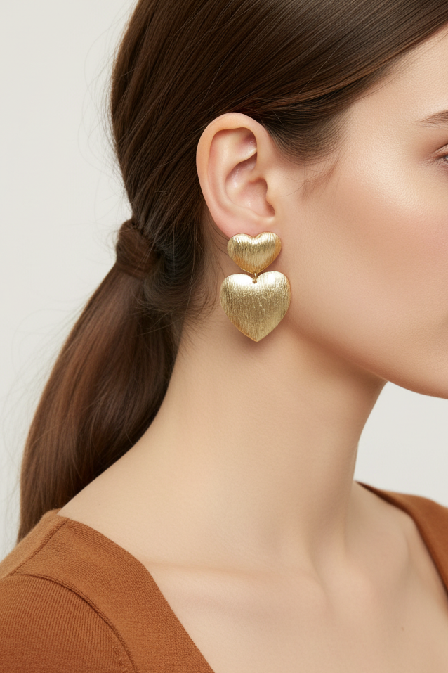 Model wearing gold double heart dangle earring - Lilylin Designs