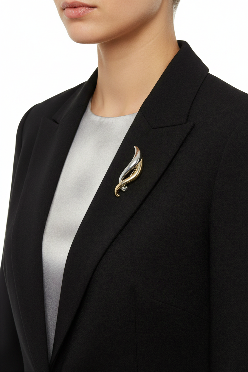 Model wearing gold and silver entwined bars pin on a black jacket with a gray shirt - Lilylin Designs
