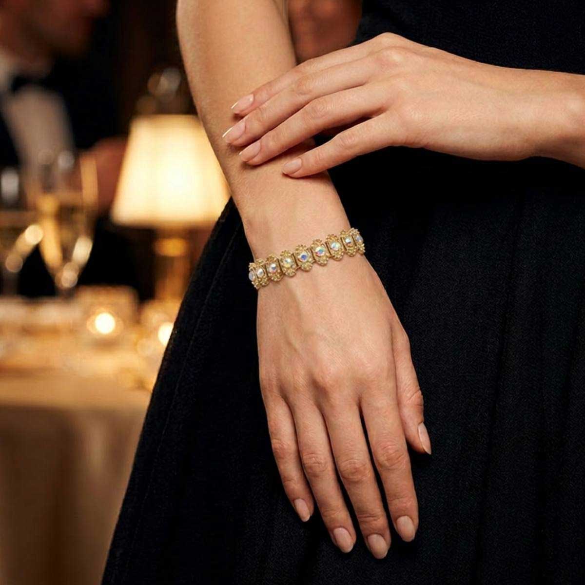 Woman wearing gold crystal stretch bracelet at dinner - Lilylin Designs