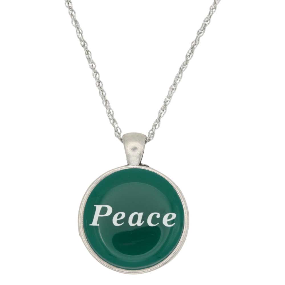 A silver chain necklace with a round pendant featuring a dark green background and the word 'Peace' written in white script, set against a plain white background - Lilylin Designs