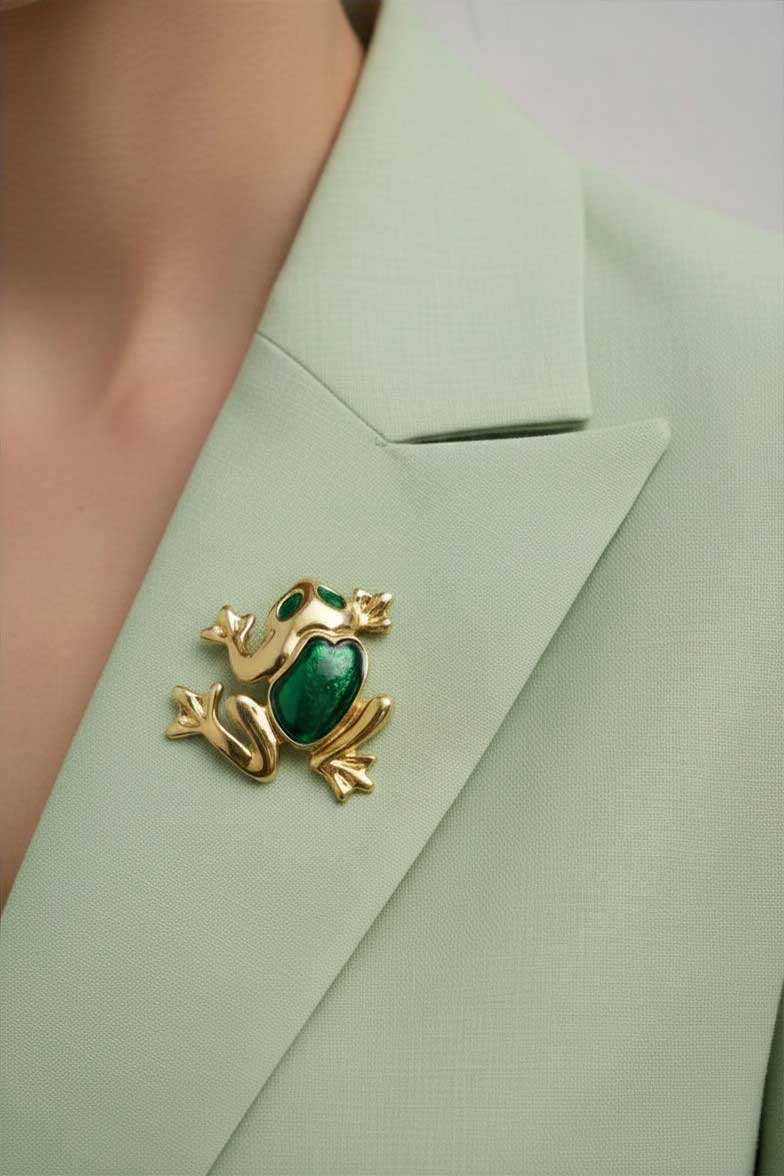 Woman wearing light green jacket with green enamel frog pin - Lilylin Designs