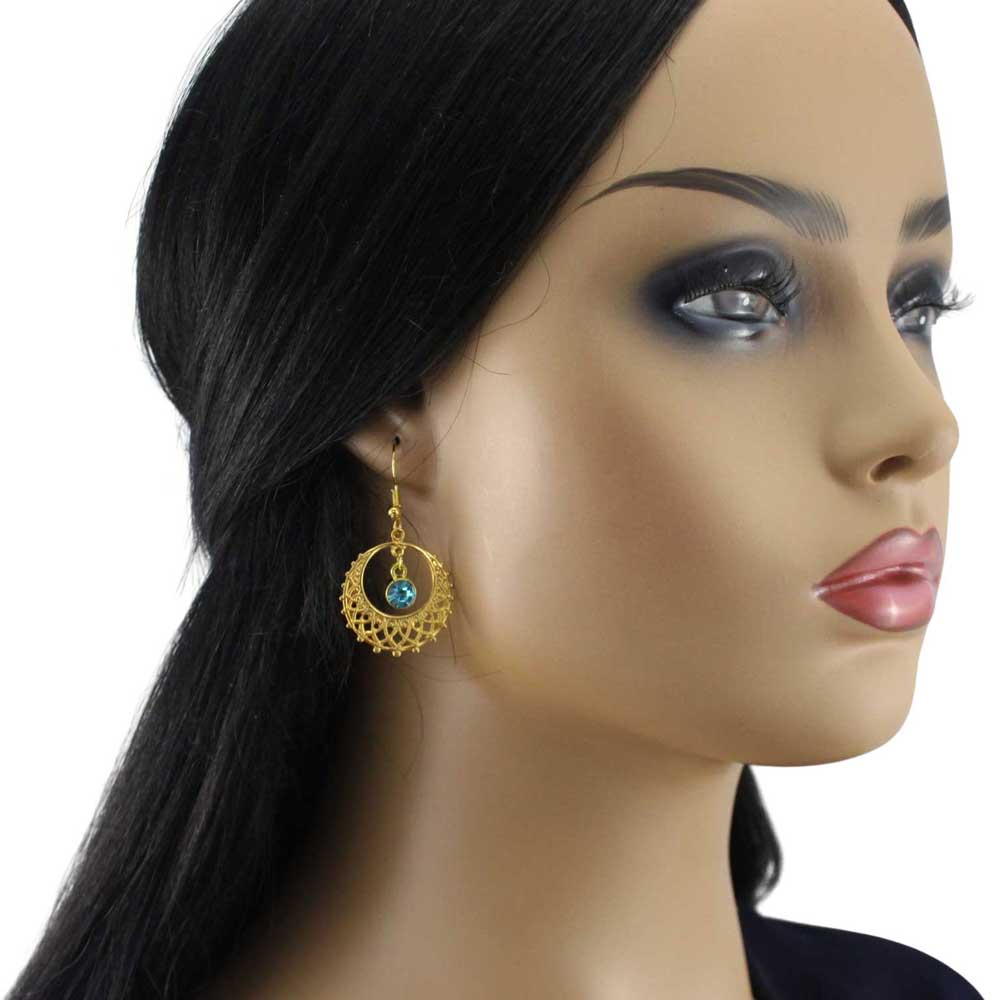 Model wearing gold filigree earring with blue crystal - Lilylin Designs