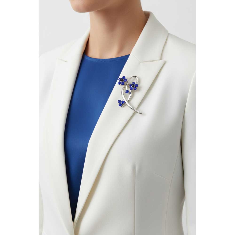 Model wearing 2 blue crystal flower in a loop brooch pin on a white jacket with a blue top - Lilylin Designs