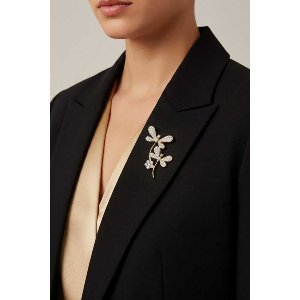 Model wearing 2 crystal dragonflies brooch pin on a black jacket with a gold top - Lilylin Designs
