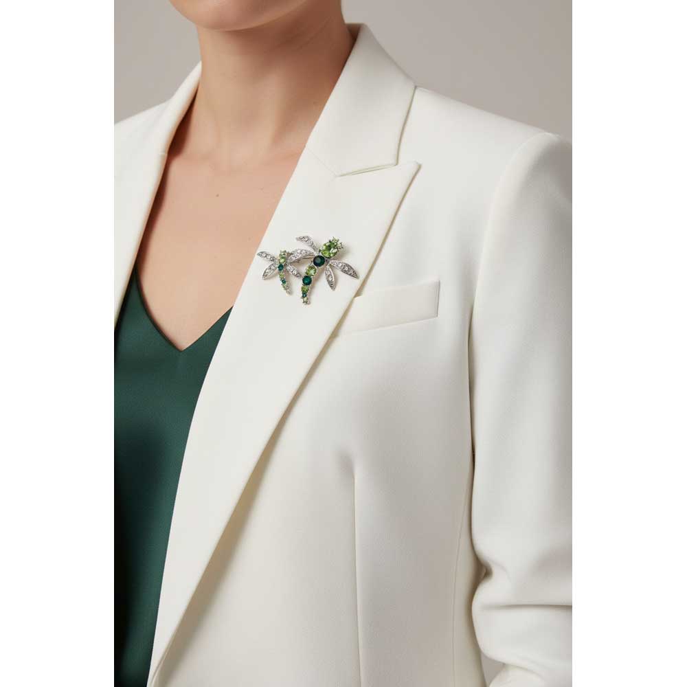 Model wearing 2 green crystal dragonflies brooch pin on a white jacket with a green top - Lilylin Designs