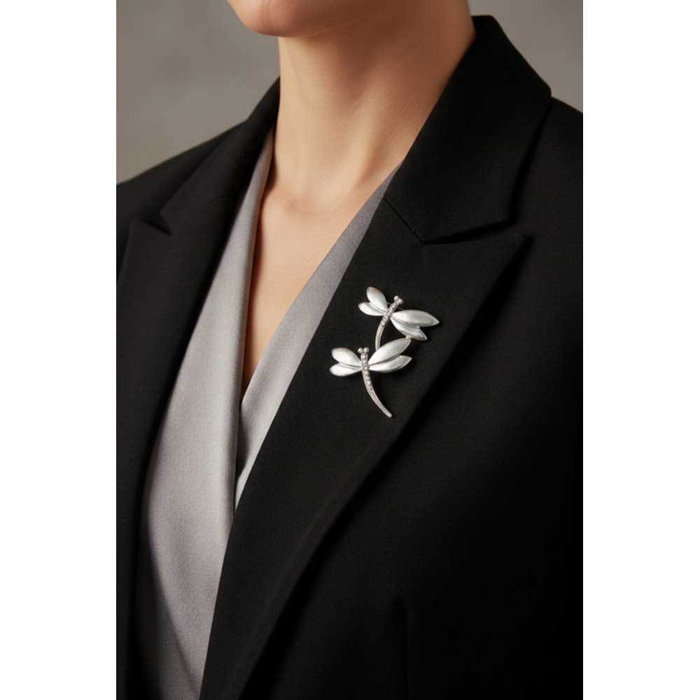Model wearing 2 silver dragonflies brooch pin on a black jacket with a gray top - Lilylin Designs