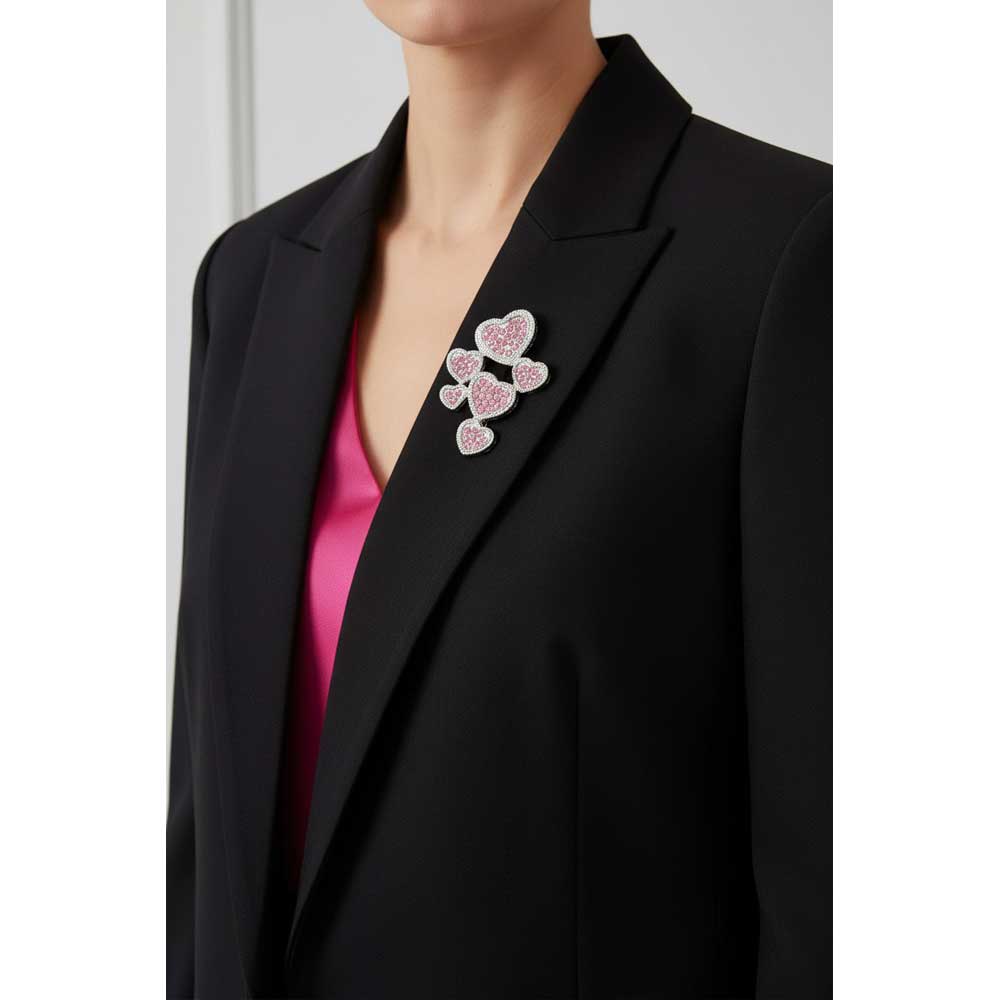 Model wearing 6 pink crystal hearts brooch pin on a black jacket - Lilylin Designs