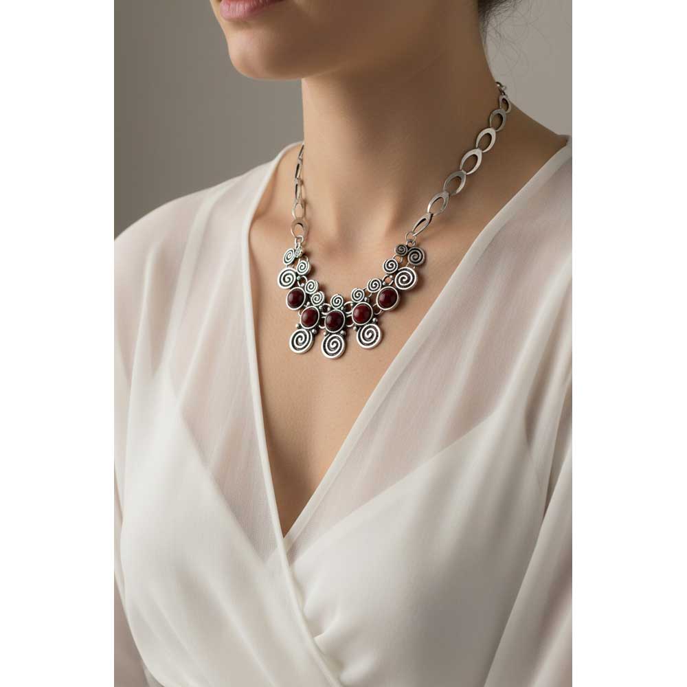 Model wearing Antique swirls with red stone necklace with a sheer white top - Lilylin Designs