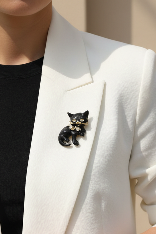 Model wearing black cat with crystal bow pin on a white jacket - Lilylin Designs