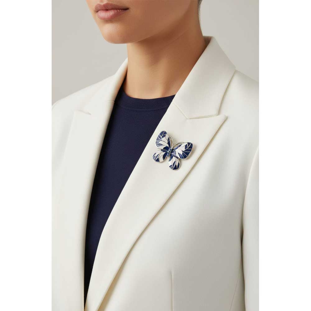 Model wearing Blue and white butterfly brooch pin on a white jacket with a navy blue top - Lilylin Designs