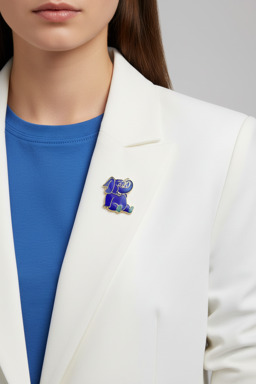 Model wearing blue cloisonne elephant pin on a white jacket - Lilylin Designs