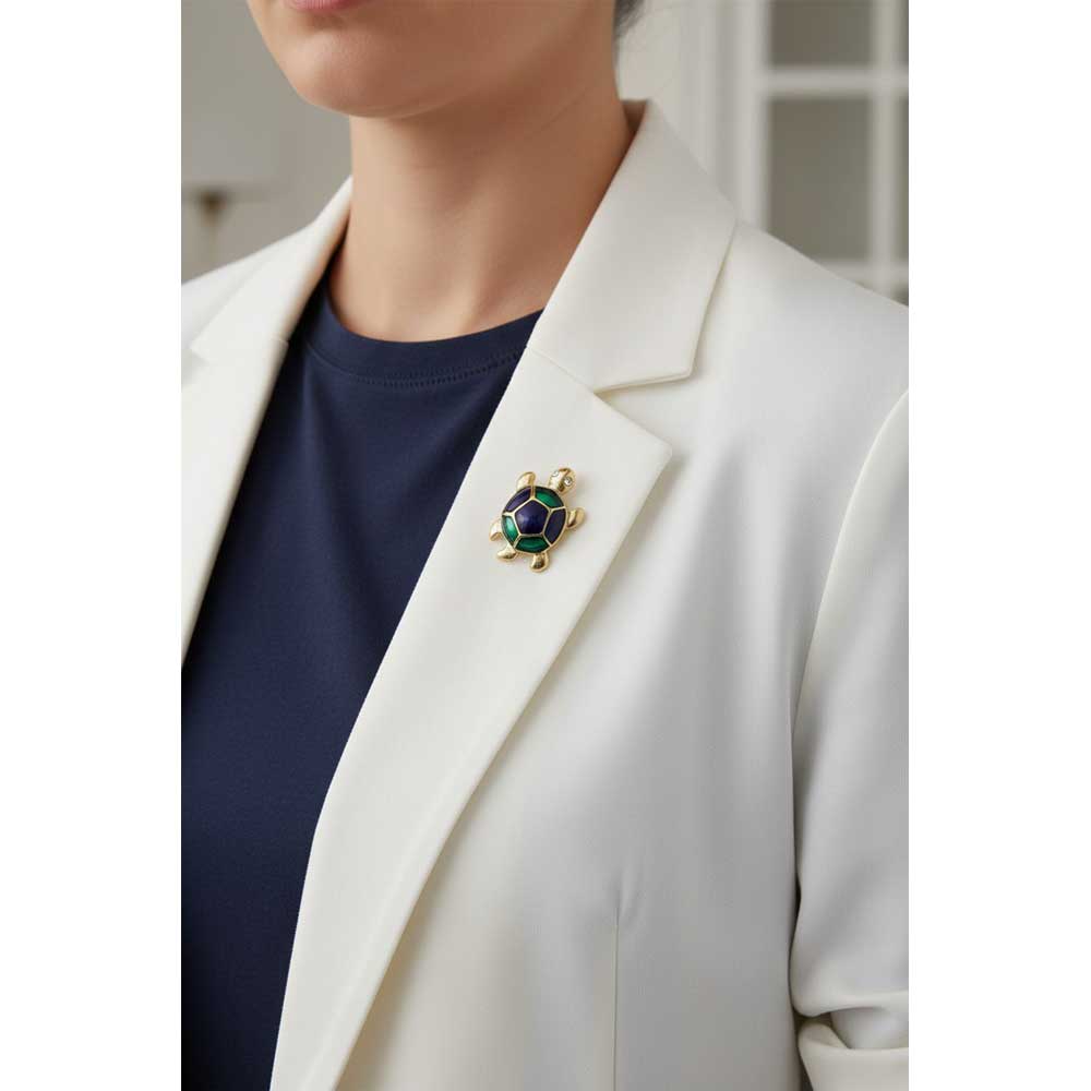 Model wearing Blue green turtle lapel tac pin on a white jacket with a navy blue t-shirt - Lilylin Designs
