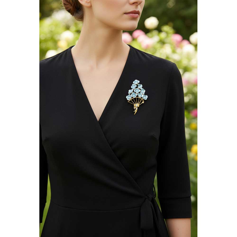 Model wearing Bouquet of blue flowers brooch pin on a black wrap dress with a flower garden background - Lilylin Designs