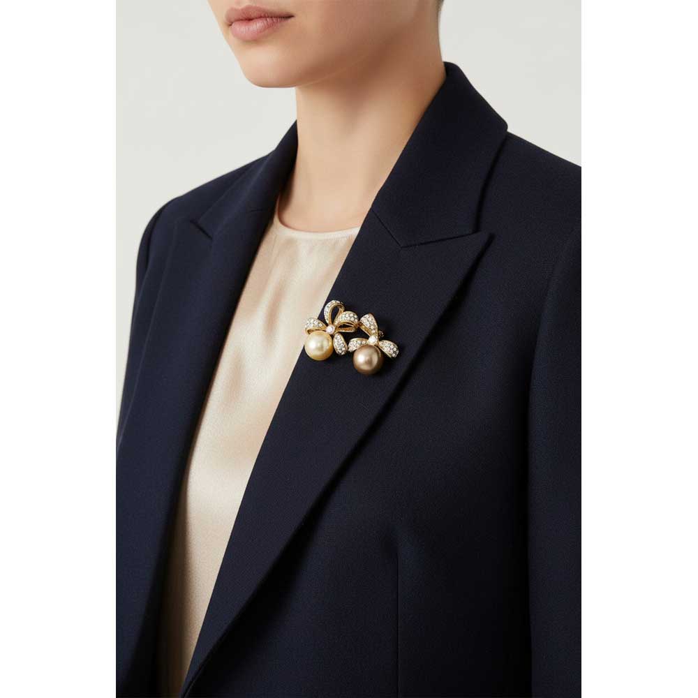 Model wearing Brown and cream pearl bow pin on a navy blue jacket - Lilylin Designs