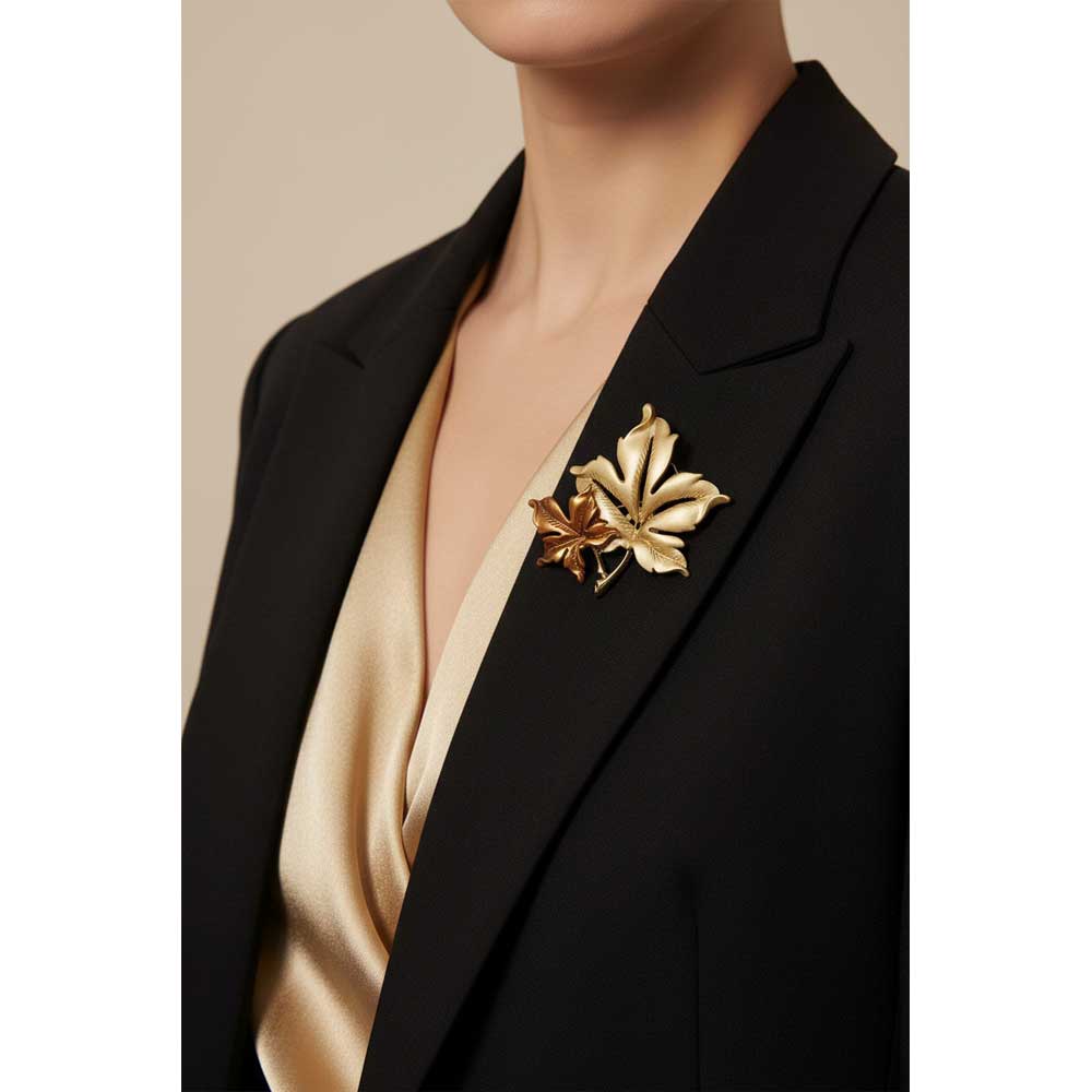 Model wearing Brown and gold maple leaves pin on a black jacket with a gold top - Lilylin Designs