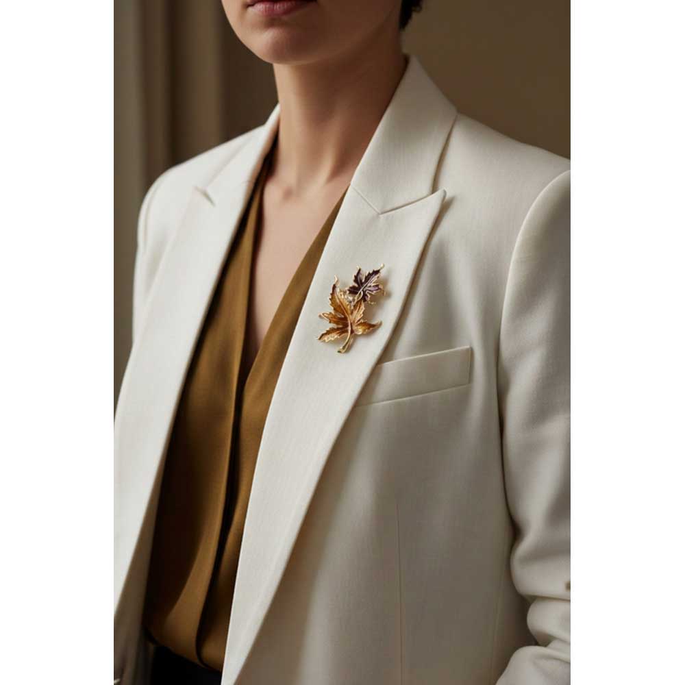 Model wearing Burgundy and gold maple leaf brooch pin on a white jacket - Lilylin Designs