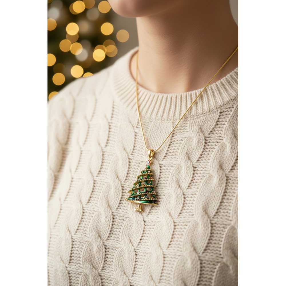 Model wearing Christmas tree necklace with a cream cable knit sweater with blurred Christmas lights in the background - Lilylin Designs