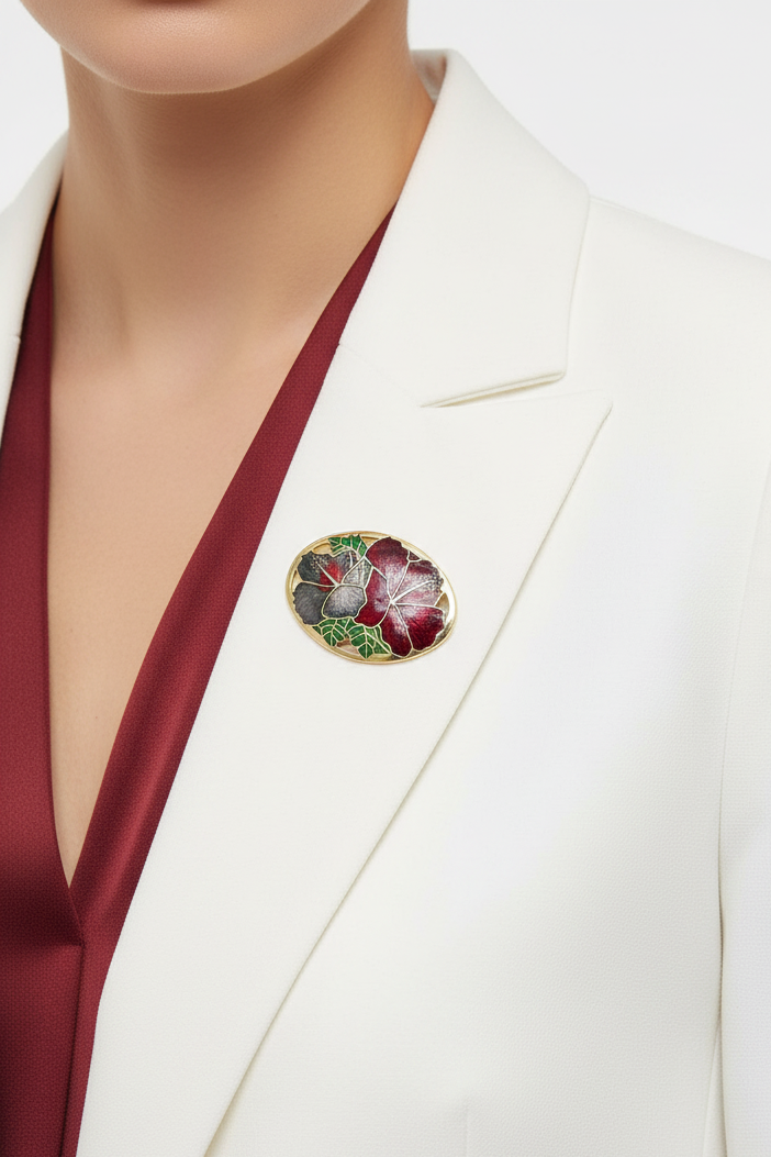Model wearing red and gray hibiscus cloisonne brooch on a white jacket - Lilylin Designs