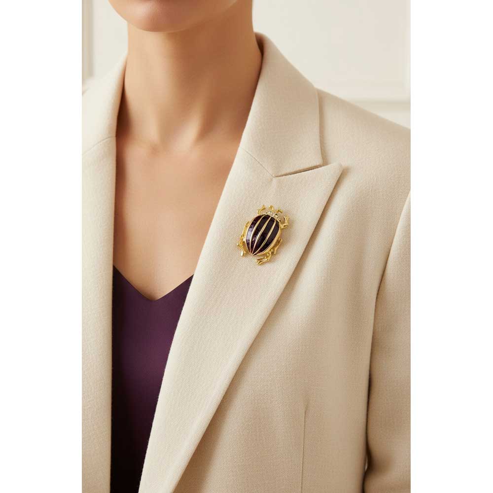 Model wearing Dark purple beetle brooch pin on a cream jacket with a purple top - Lilylin Designs