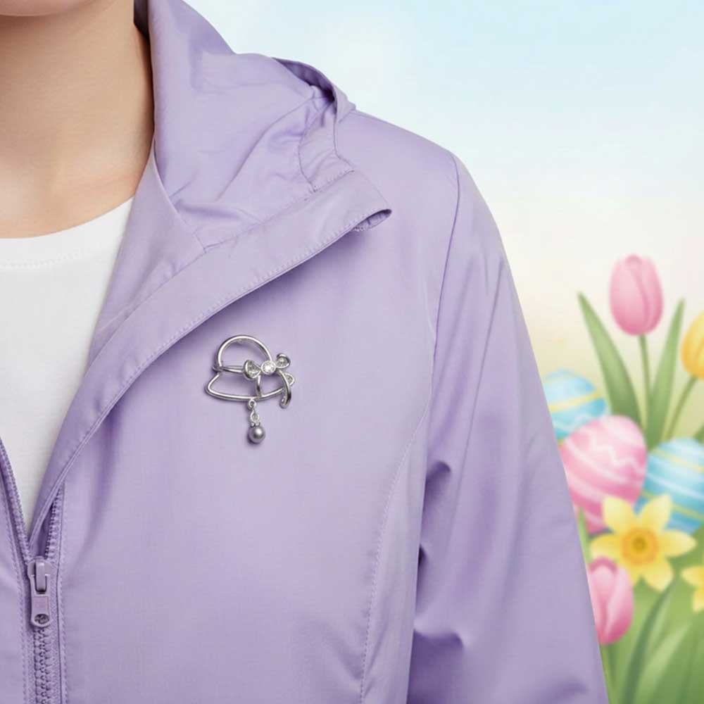 Model wearing Easter bonnet lapel tac pin on a light purple jacket with a Easter background - Lilylin Designs