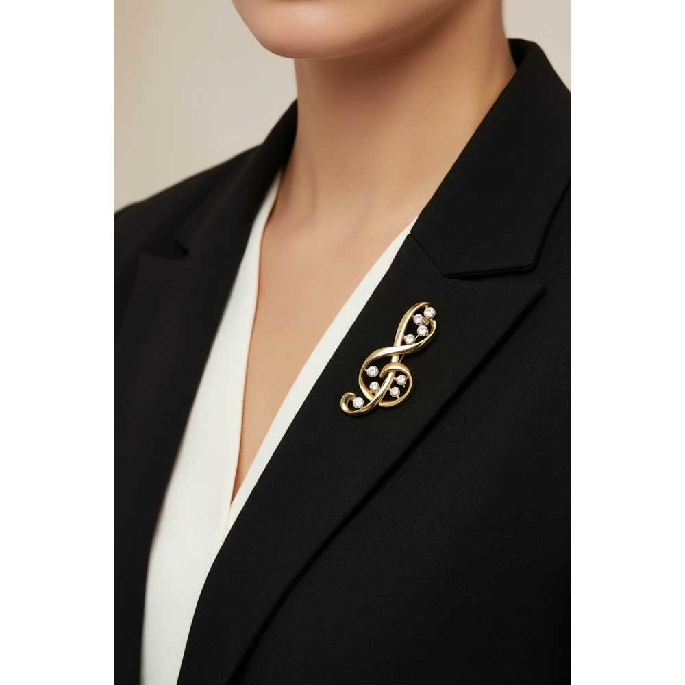 Model wearing G-clef brooch pin on a black jacket with a white top - Lilylin Designs