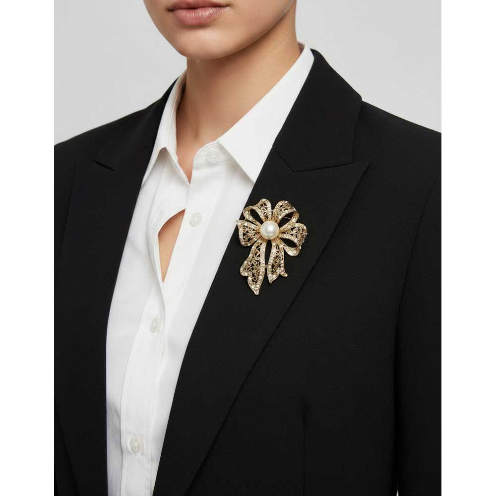 Model wearing Gold filigree bow with pearl brooch pin on a black jacket with a white shirt - Lilylin Designs