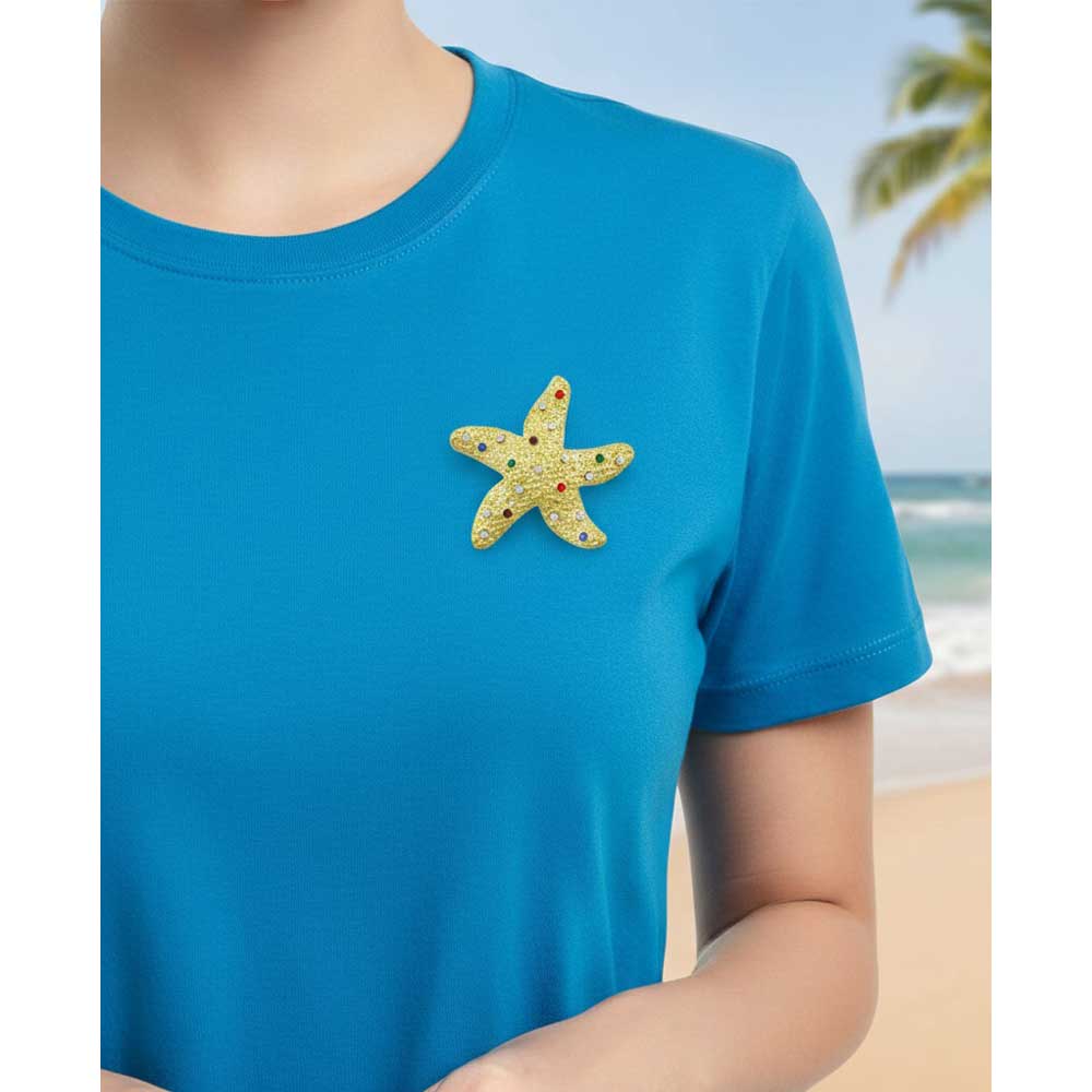 Model wearing Gold textured starfish brooch pin on a blue t-shirt - Lilylin Designs