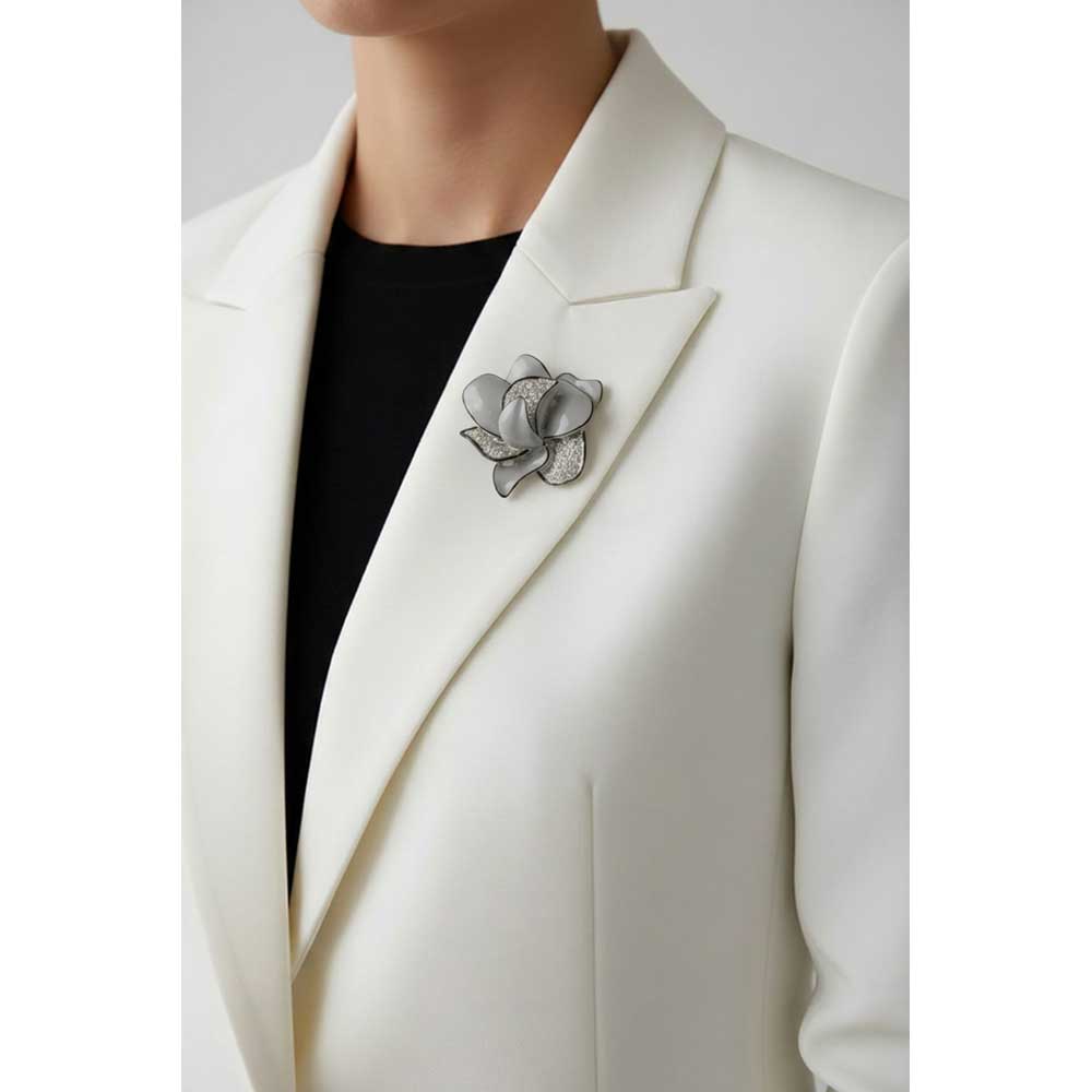 Model wearing Gray flower trimmed in black brooch pin on a white jacket with a black top - Lilylin Designs