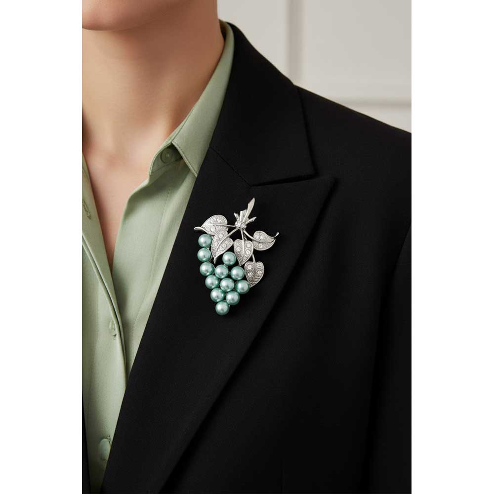Model wearing Green pearl grapes brooch pin on a black jacket with a light green shirt - Lilylin Designs