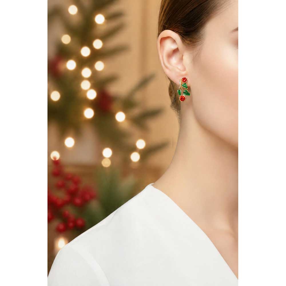 Model wearing Holly and berries clip earring with a white top and blurred holiday background - Lilylin Designs
