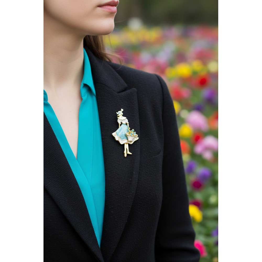 Model wearing Lady with flower basket brooch pin on a black jacket with a blue shirt with a flower garden background - Lilylin Designs