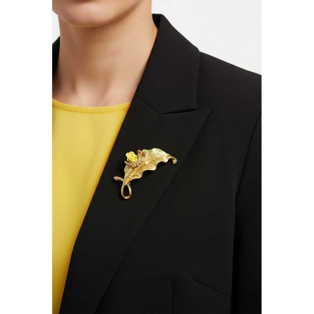 Model wearing Leaf with snail brooch pin on a black jacket with a yellow top - Lilylin Designs