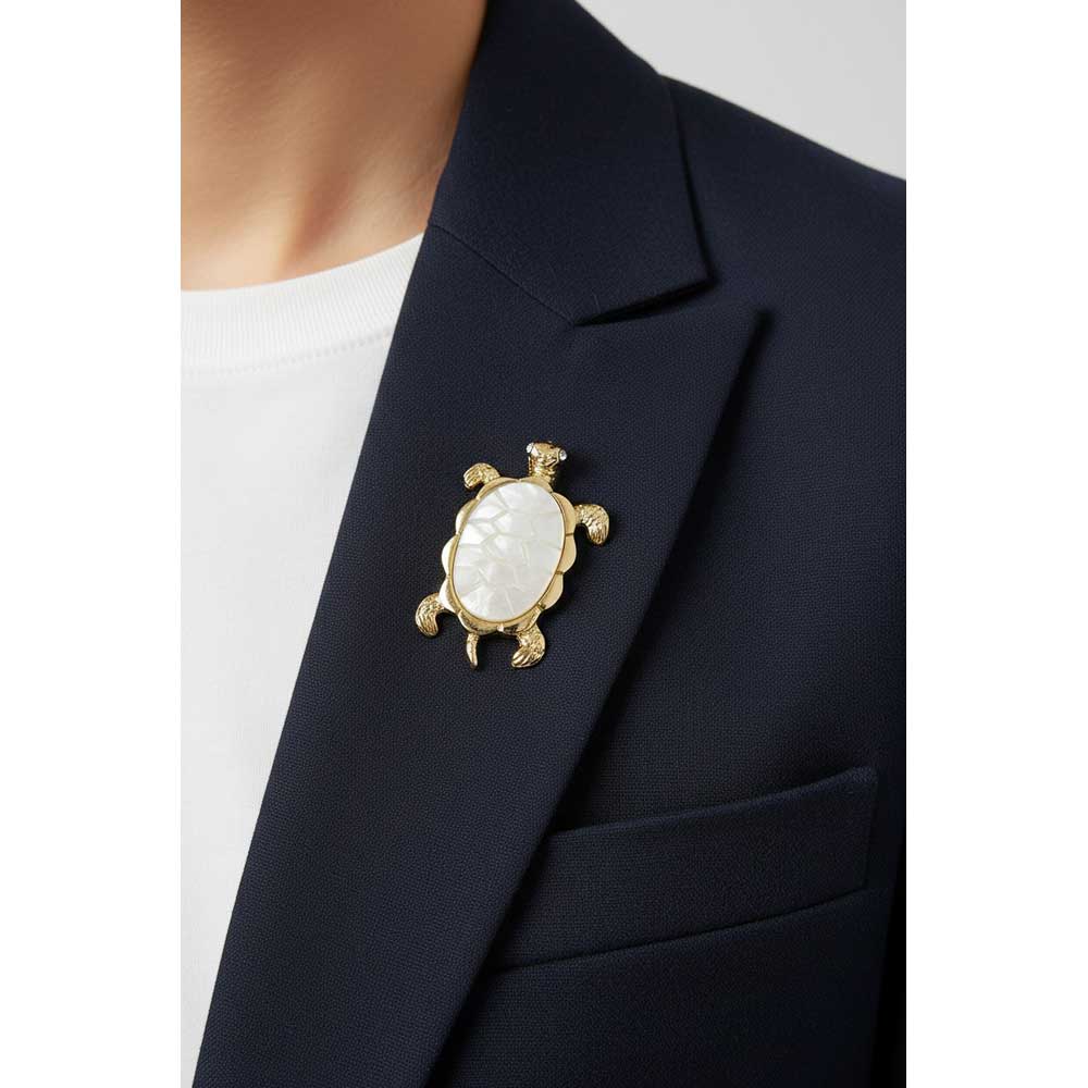 Model wearing Mother of pearl turtle pin on a navy blue jacket with a white t-shirt - Lilylin Designs