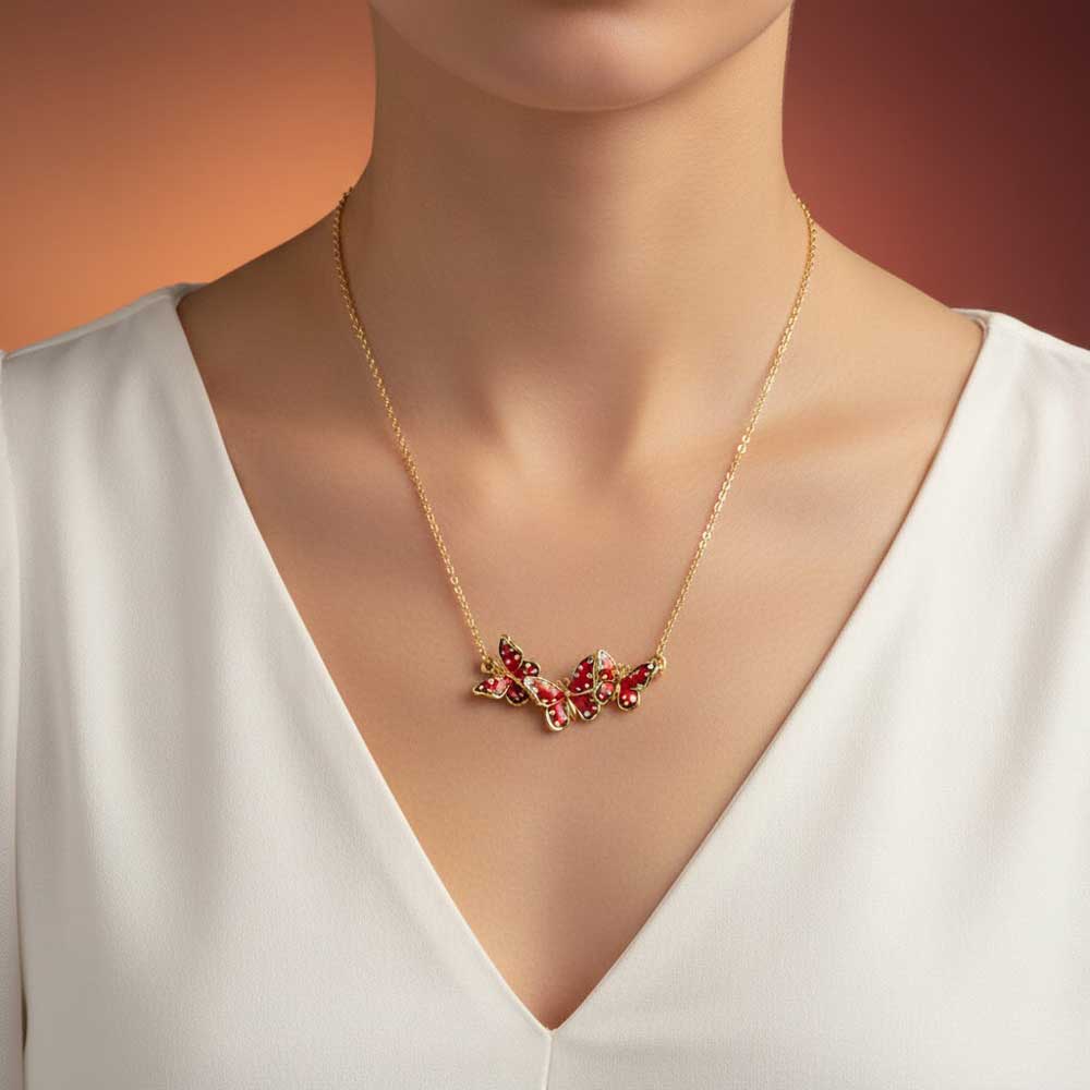 Model wearing Orange speckled butterflies necklace with a white dress - Lilylin Designs
