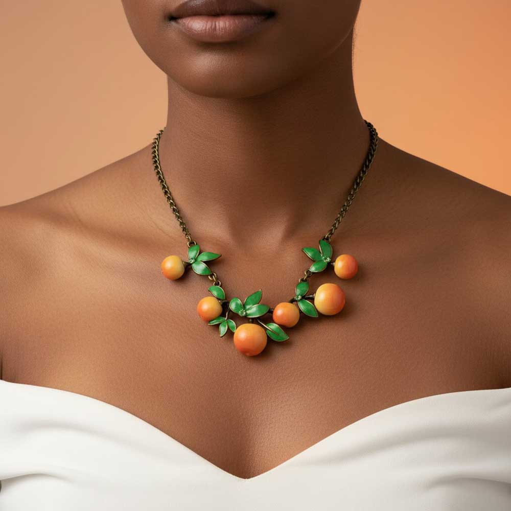 Model wearing Oranges and leaves necklace with a white off the shoulder dress - Lilylin Designs